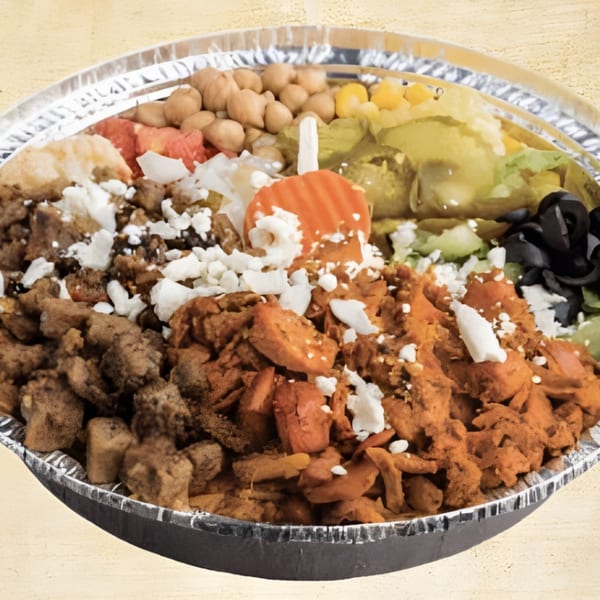 A Mediterranean bowl with chicken, gyro meat, chickpeas, olives, lettuce, and feta cheese.